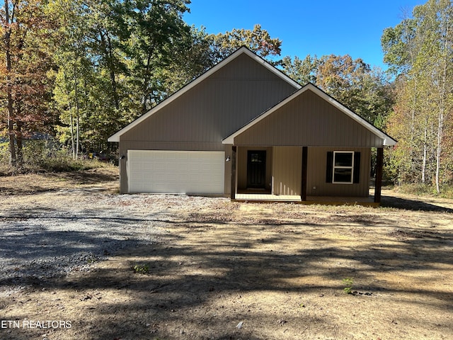 view of front of home featuring covered porch and a garage