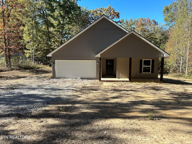 view of front of home featuring covered porch and a garage