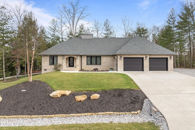 view of front of home featuring a garage and a front yard