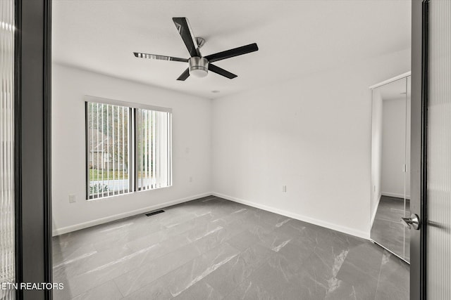 unfurnished room with ceiling fan