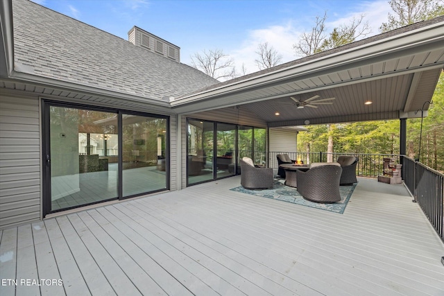 deck with outdoor lounge area and ceiling fan