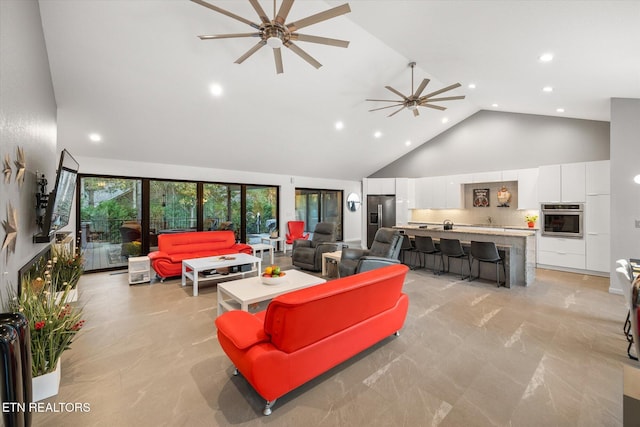 living room featuring ceiling fan and high vaulted ceiling