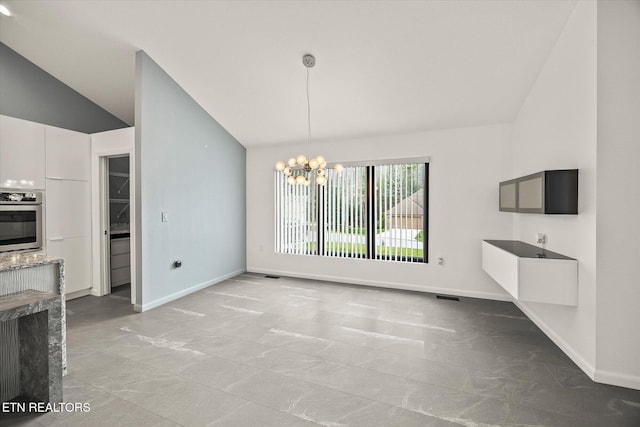 unfurnished dining area featuring lofted ceiling and an inviting chandelier