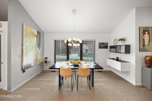 dining space with lofted ceiling and a notable chandelier