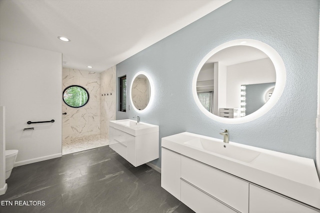 bathroom with vanity and a tile shower