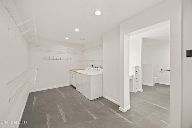 laundry room with cabinets and washer and dryer