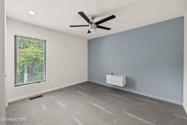 empty room with a wealth of natural light and ceiling fan