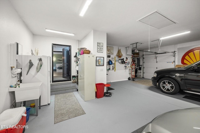 garage with white refrigerator and a garage door opener