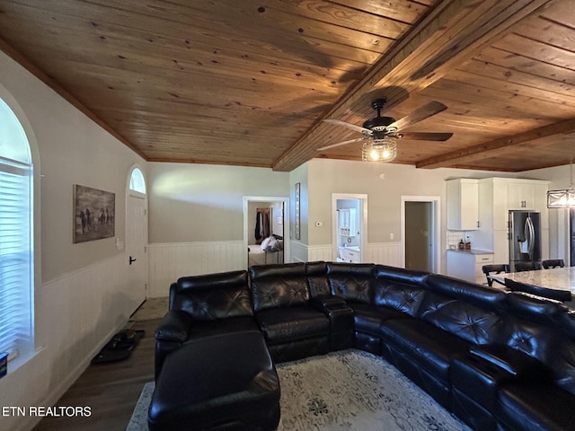 living room with ceiling fan, wood-type flooring, wooden ceiling, ornamental molding, and beamed ceiling