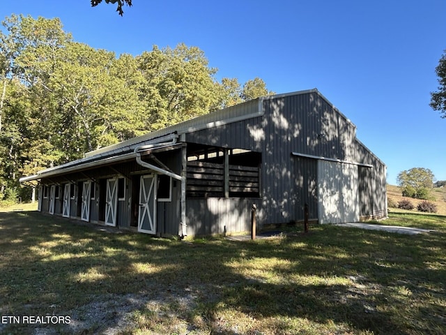 view of property exterior featuring an outdoor structure and a yard