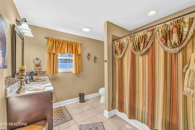 bathroom with toilet, tile patterned flooring, curtained shower, and vanity