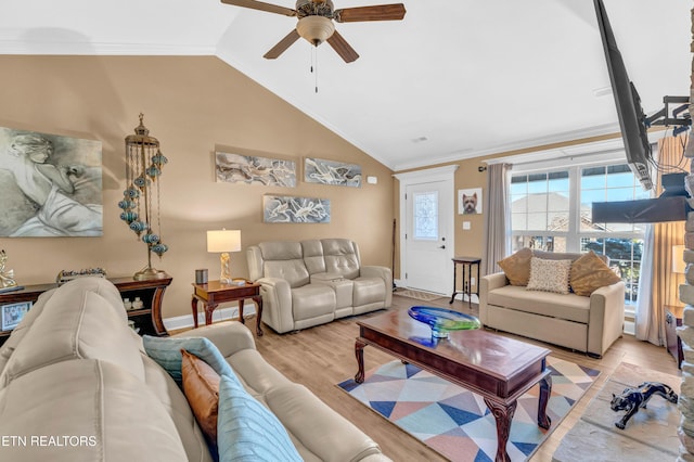 living room with vaulted ceiling, ornamental molding, ceiling fan, and light hardwood / wood-style floors