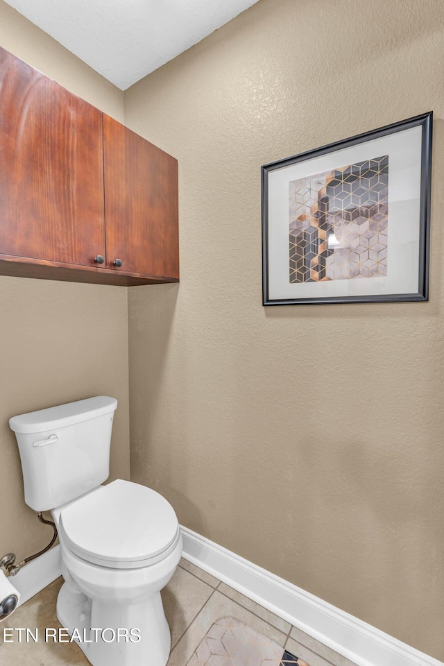 bathroom with tile patterned flooring and toilet