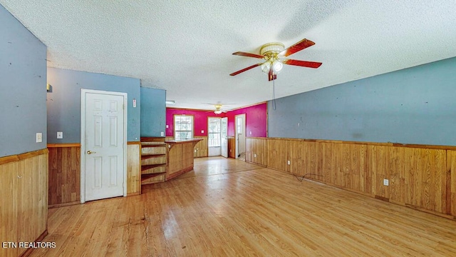 2732 Cherry Fork Rd, Helenwood, TN 37755 - interior space with a wainscoted wall, a ceiling fan, wooden walls, and wood finished floors