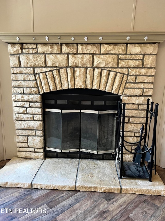 room details with a fireplace and hardwood / wood-style flooring