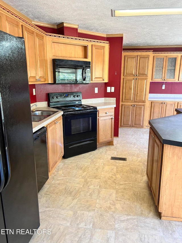 kitchen featuring sink, black appliances, crown molding, and a textured ceiling