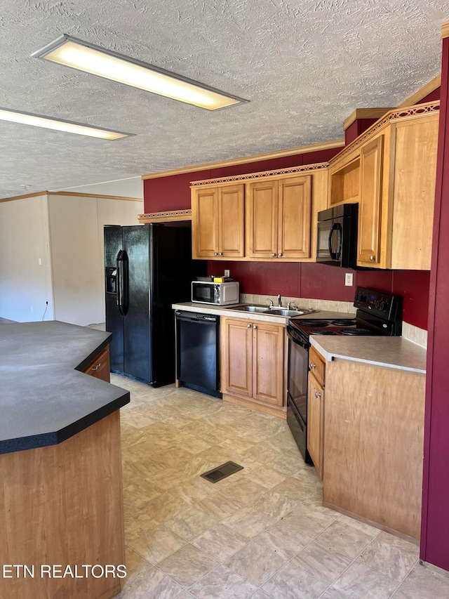 kitchen featuring ornamental molding, a textured ceiling, black appliances, and sink