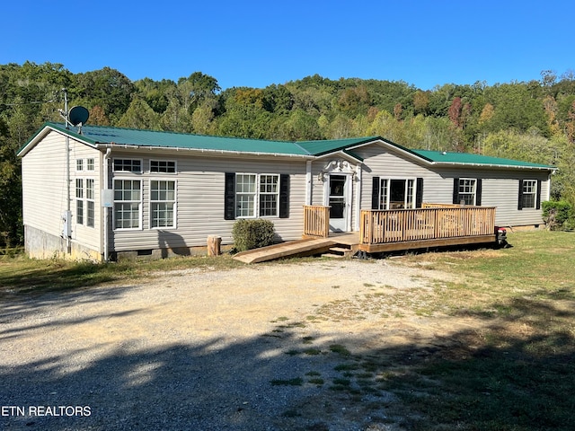 view of front facade featuring a front lawn and a deck