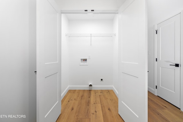 washroom featuring hookup for a washing machine, electric dryer hookup, and light hardwood / wood-style floors