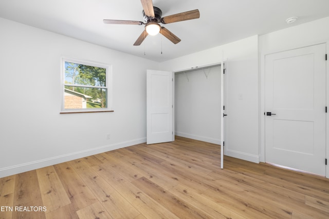 unfurnished bedroom featuring a closet, light hardwood / wood-style floors, and ceiling fan