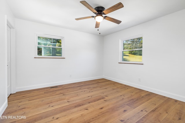 spare room featuring light wood-type flooring and ceiling fan