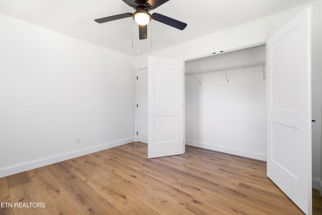 unfurnished bedroom featuring light hardwood / wood-style flooring, a closet, and ceiling fan