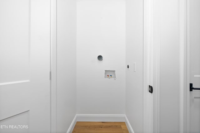 clothes washing area with hookup for an electric dryer, hookup for a washing machine, and wood-type flooring