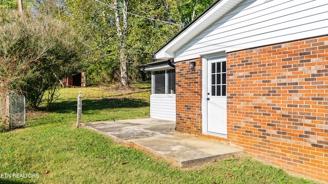 doorway to property featuring a yard and a patio