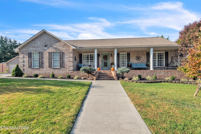 ranch-style house with a front yard and covered porch