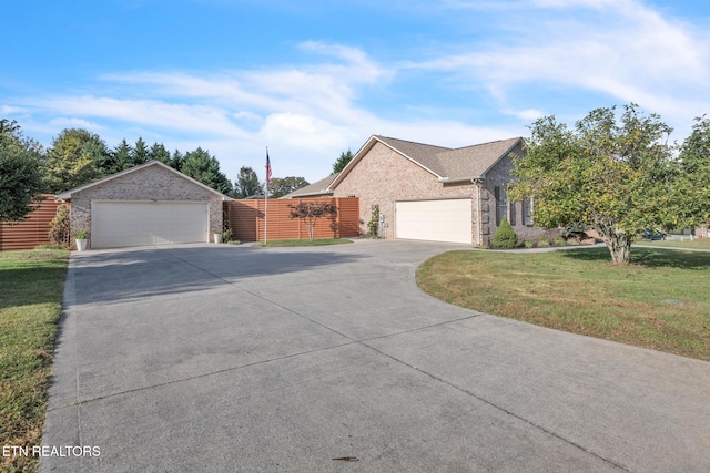 ranch-style home featuring a front lawn and a garage