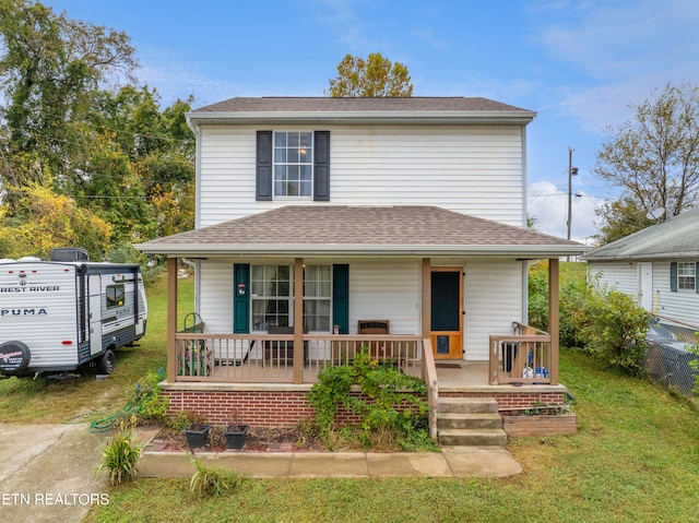 view of front of house featuring covered porch and a front yard