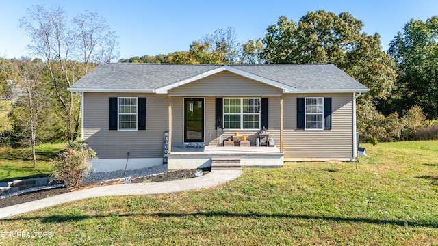 ranch-style home featuring a porch and a front yard