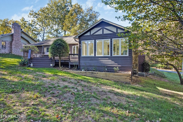 rear view of house featuring a yard and a deck