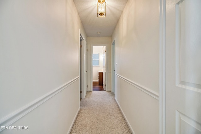 corridor featuring a textured ceiling