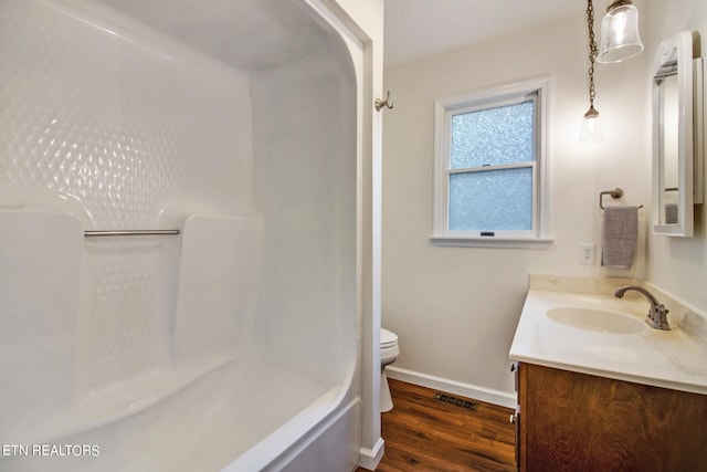 full bathroom featuring shower / bathing tub combination, vanity, wood-type flooring, and toilet