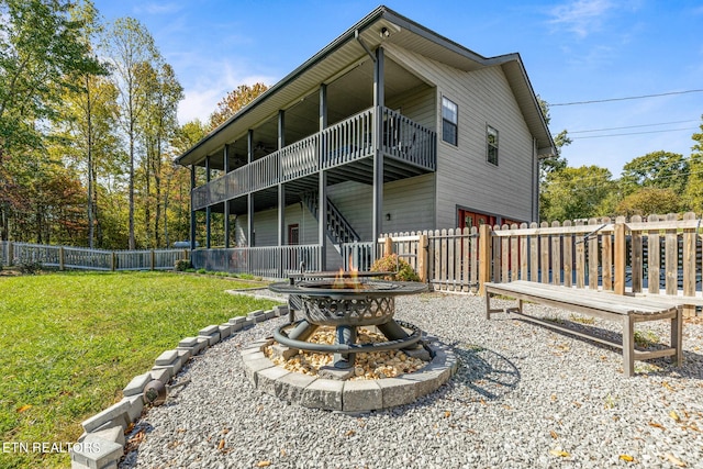 back of property with a yard, a patio area, and a balcony