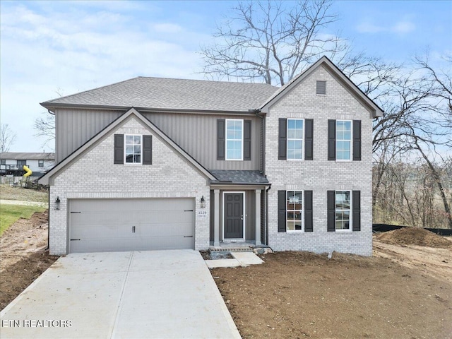 traditional-style home with driveway, a garage, a shingled roof, board and batten siding, and brick siding