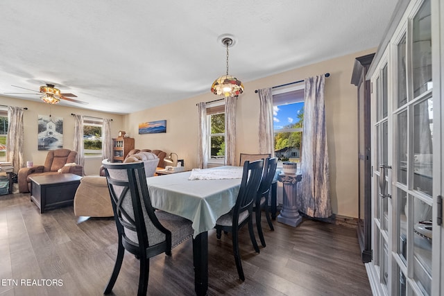 dining room featuring a textured ceiling, dark wood finished floors, a ceiling fan, and baseboards