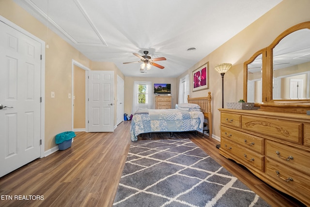 bedroom featuring a ceiling fan, dark wood-style flooring, and baseboards