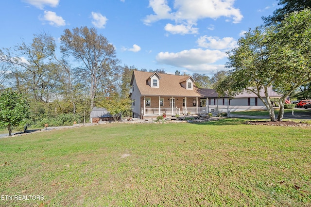 view of front of property with a porch, brick siding, and a front lawn