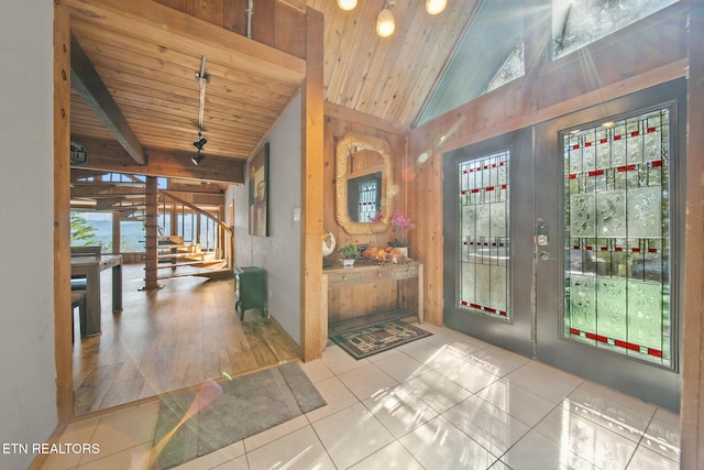 tiled entrance foyer with vaulted ceiling with beams, wooden ceiling, and plenty of natural light