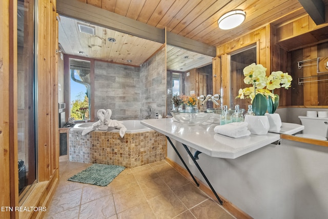 bathroom with toilet, a healthy amount of sunlight, wooden ceiling, and tiled tub