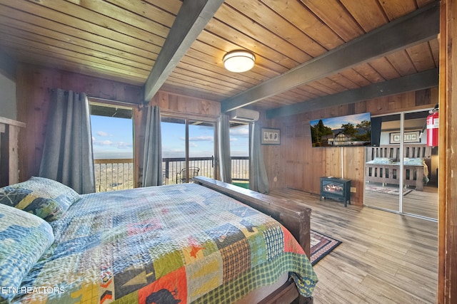 bedroom featuring beam ceiling, hardwood / wood-style floors, multiple windows, and wooden ceiling