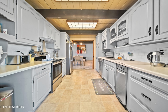 kitchen featuring beamed ceiling, decorative backsplash, stainless steel appliances, and wooden ceiling