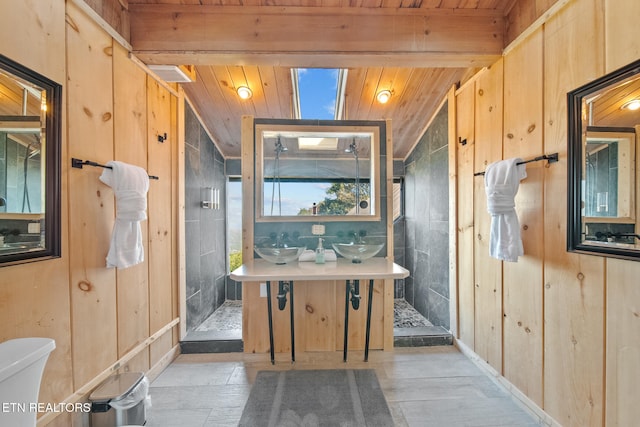 bathroom featuring a shower, wooden ceiling, toilet, vanity, and wooden walls