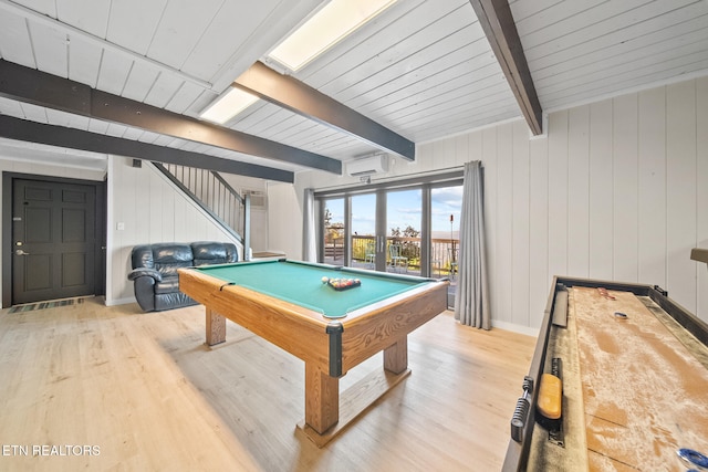 game room featuring beam ceiling, pool table, light hardwood / wood-style floors, and wood walls