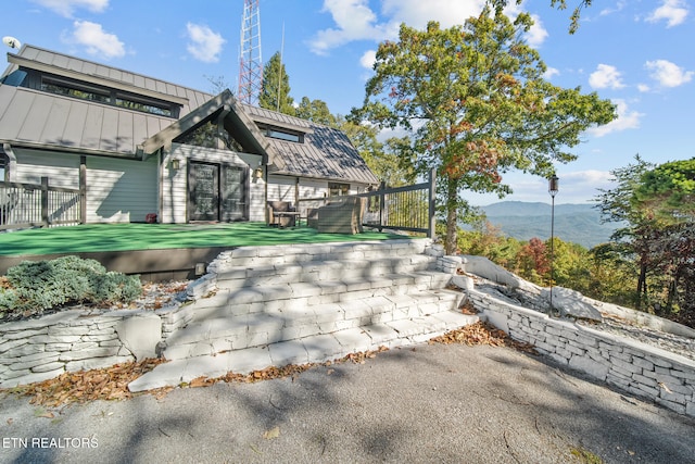 exterior space with a deck with mountain view