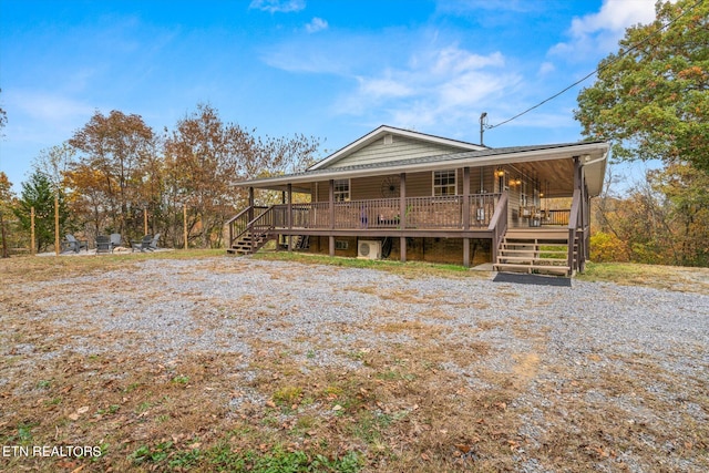 farmhouse-style home with a wooden deck