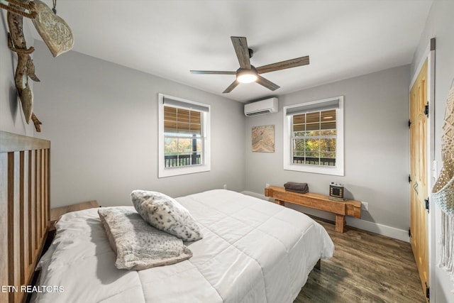 bedroom with dark wood-type flooring, a wall unit AC, and ceiling fan