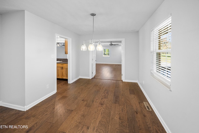 unfurnished dining area with dark hardwood / wood-style floors and ceiling fan